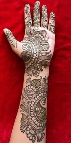 the hand is decorated with henna on it