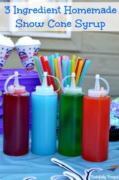 three different colored bottles with toothbrushes and straws in them on a table