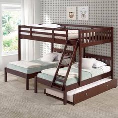 the bunk bed is made up with two sets of mattresses and a pull out trundle