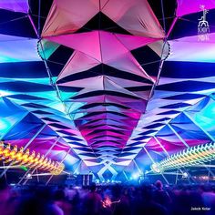 the ceiling is covered with colorful lights and shapes that are suspended from it's sides