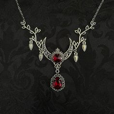 "This enchanting moon elf necklace features richly detailed antiqued silver tone filigree crescent, intricate leafy branches and elegant scroll drop accents. Its captivating design is adorned with dazzling dark ruby red glass crystals. Decorated portion is 4 1/2\" wide and 2 1/2\" tall in the very center.  Necklace length is adjustable with soldered stainless steel cable chain, lobster clasp and extender. If you would like a different length, please send us a message. Matching headpiece, pendant and earrings are listed separately in our store. If you don't see items with a color you want, feel free to ask about availability." Red And Silver Necklace, Medieval Necklace Pendants, Ruby Stone Necklace, Elf Necklace, Moon Elf, Medieval Necklace, Filigree Necklaces, Fairy Necklace, Choker Pendant