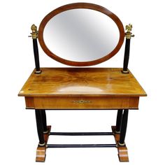 an antique wooden vanity with mirror on it