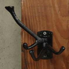 an iron hook on the side of a wooden door