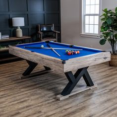 a pool table in the middle of a living room