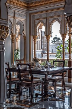 an ornate dining room with marble floors and walls