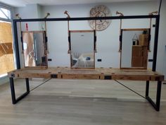 a wooden bench with mirrors on it in a room