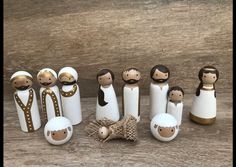 a group of wooden dolls sitting next to each other on top of a wooden table