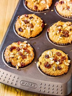 several muffins in a tray on a wooden table