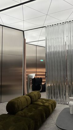 a living room filled with lots of furniture and walls covered in frosted glass panels