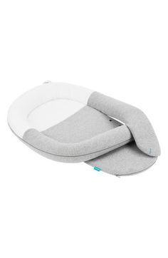 the grey and white baby seat is attached to an infant's bed with a pillow on