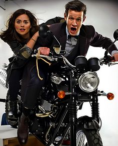 a man and woman riding on the back of a motorcycle with an angry look on their face