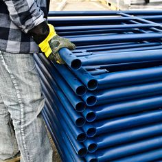 a man is working on some blue pipes