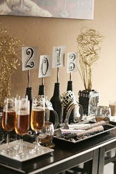 a table topped with lots of wine glasses and bottles