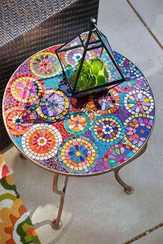 a colorful mosaic table with a potted plant on top