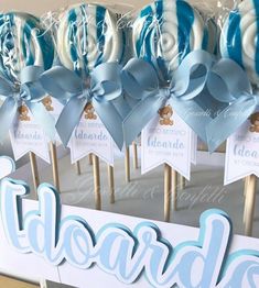 blue and white lollipops are on sticks in front of a sign with the word teddybear