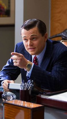 a man in a suit sitting at a desk