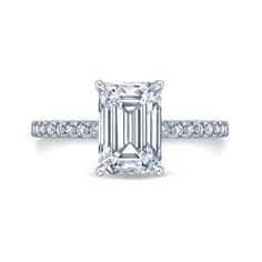 an emerald cut diamond engagement ring with pave set diamonds on the band and side stones