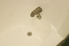 a close up of a faucet on the side of a bathtub