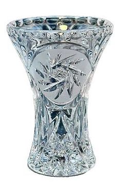 a clear glass vase with an intricate design on the top and bottom, sitting in front of a white background