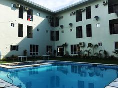 an empty swimming pool in front of a building