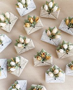 several origami flowers are placed on top of each other in small envelopes