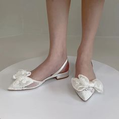 Lace Bow Bridal Slingback Flats | Bella Belle Feminine Low Heel Slingback Pumps For Wedding, Feminine Low Heel Sandals For Weddings, Summer Lace Wedding Shoes With Low Heel, Spring Wedding Shoes In Cream Lace, Elegant Summer Wedding Shoes With Lace, Elegant Summer Wedding Shoes In Lace, Cream Lace Wedding Shoes For Spring, Elegant Wedding Shoes With Laces, Elegant Lace Wedding Shoes For Summer