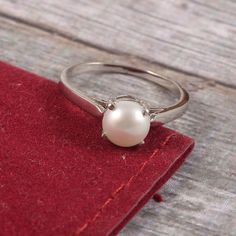 "This Sterling Silver Ring features an Elegant Art With Natural Pearl Gemstone. The cavity is made from genuine solid 925 sterling silver and stamped as S925. This Jewelry is Lead free and Rhodium plated to resist scratches and tarnish. ITEM DESCRIPTION Item Code: JARG160 Metal: 925/92.5 Sterling Silver Gemstone: Genuine Natural Cultured Pearl Gemstone Shape: Round Gemstone Size: 7 MM Round Ring Length: 7 MM Ring width: 7 MM Weight: 2.17 gm approx **Keep the jewelry away from direct heat, water, Silver Pearl Ring For Women, Elegant Silver Rings With Birthstone, Silver Sterling Silver Pearl Ring With Polished Finish, Sterling Silver Open Pearl Ring With Polished Finish, Oval Sterling Silver Pearl Ring In Fine Jewelry Style, Sterling Silver Pearl Ring With Polished Finish, Fine Jewelry Sterling Silver Pearl Ring With Oval Shape, Fine Jewelry Oval Pearl Ring In Sterling Silver, Oval Sterling Silver Pearl Ring