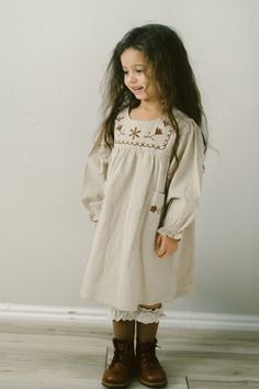 Our Ava girls embroidered long sleeve dress is perfect for Fall and Winter. Dress is tan color with cute brown embroidery on bodice and pockets. Dress is the perfect length for pairing with winter boots and socks. Comfortable fit True to size Model is 4T wearing 4T dress 100% cotton Hand wash, line dry Socks sold separately Baby Winter Dress, Boots And Socks, Warm Winter Dresses, 4t Dress, Girls Fall Dresses, Brown Embroidery, Neutral Dresses, Long Sleeve Embroidered Dress, Girls Winter Dresses