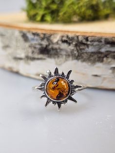 Welcome to handmade Baltic Amber jewelry shop. This Item is made of genuine, natural Amber. This item will make You look simple but gorgeous. Sun shape ring. Brown Baltic amber jewelry. Amber rings. Real gemstone statement ring. Crystal ring. Flaming sun shape small ring. One ring included.  sun size 1.4 cm.   Our handmade jewelry is made with passion and love. If you have any problems with your order please contact us. Please note that colors can vary from originals depending on computer monitor's settings. Due to amber is being unique and natural gemstone, each item may be slightly different in shades or shapes. Items may have natural imperfections like lines and spots, specks, coloration and inclusions, layers and lines .  All amber is fossilized tree resin and it is extremely light gem Minimalist Amber Sterling Silver Jewelry, Minimalist Sterling Silver Amber Jewelry, Adjustable Round Jewelry With Sun Design, Adjustable Round Sun Design Jewelry, Unique Round Jewelry With Sun Design, Minimalist Sterling Silver Jewelry With Sun Design, Unique Round Sun Design Jewelry, Sterling Silver Sun Design Ring For Gift, Sterling Silver Ring With Sun Design For Gift