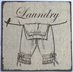 an image of laundry hanging on a line with the word laundry written above it in cursive writing