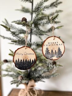 two wooden ornaments hanging from a christmas tree