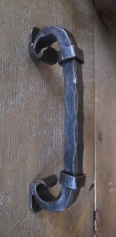 a metal hook on the side of a wooden door