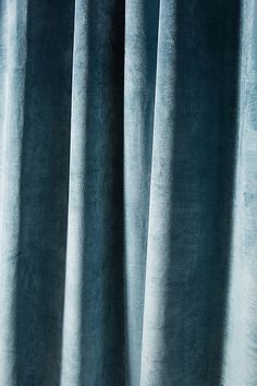 a close up view of a blue curtain