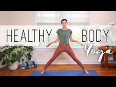 a woman standing on a yoga mat in front of a window with the words, healthy body yoga