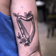 a tattoo on the arm of a man with a harp