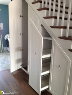 an open closet under the stairs in a house