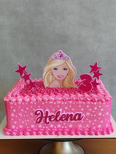 a barbie birthday cake with pink frosting and stars