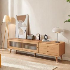 a living room scene with focus on the entertainment center and plants in the corner,