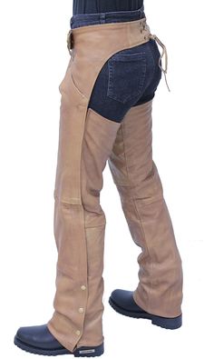 Women's Arizona brown leather chaps with deep pant style pockets. These brown chaps are not only great looking and sexier than those classic unisex chap styles but it's made with a soft antique finish on lambskin leather. Women's biker chaps with an adjustable front belt, soft nylon lining, wind flaps cover leg zippers, a four snap bottom so it can be easily cut to length, and made of a soft lambskin leather. Layered with a pair of jeans to give you the protection you need when you ride. Sizes: XS, S, M, L, XL, 2X, 3X, 4X, 5X. +$10 for 2X-3X, +$20 for 4X-5X. [5#] two deep pants style pockets adjustable buckle up front leather laced back belt for added adjustment side zipper wind flaps hides zippers YKK quality zippers snap cuffs makes it easy to trim to length soft nylon lining top grain l Western Style Bottoms With Belt Loops For Fall, Winter Leather Pants With Belt Loops, Fitted Western Brown Bottoms, Fitted Brown Western Bottoms, Western Full-length Fall Bottoms, Western Style Full Length Bottoms For Fall, Western Style Brown Bottoms For Fall, Brown Full-length Leather Pants With Pockets, Brown Full Length Leather Pants With Pockets