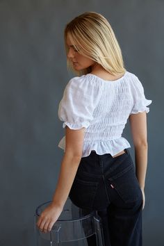 Day or night, you can't go wrong with the Melissa Puff Sleeve Crop Top! This feminine top features a v neckline, smocked bodice, puff sleeves, and a ruffle hem. Pair with Levi's Ribcage Wide Leg Jeans in Rosie Posie to compete the look! Details 100% Cotton Slip on Elastic band on sleeves Hand wash cold / Line dry Fitted Smock V-neck Top, Fitted V-neck Blouse With Smocked Cuffs, Billowy V-neck Top With Ruffles, Feminine Puff Sleeve Top With Ruffles V-neck, Feminine V-neck Puff Sleeve Top With Ruffles, Fitted Cropped Puff Sleeve Top With Ruffles, Fitted Puff Sleeve Top With Ruffles, Cropped, Feminine V-neck Tops With Smocked Cuffs, Billowy Smocked Top With Ruffles