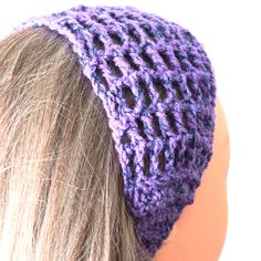 a woman's head wearing a purple crochet hat