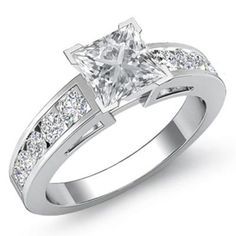 a princess cut diamond engagement ring with channeled diamonds on the band and shoulders, set in white gold