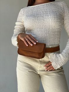 "Check out other products from our shop below:  https://www.etsy.com/shop/MandrnStudio The Ziggy zags across the intersection of timeless elegance and practical versatility with all of its wearable options, making you look effortlessly chic. Wear it 4 ways as a fanny pack, crossbody, clutch, and a stand-alone belt.  PRODUCT FEATURES: 100% premium cowhide leather locally sourced in Indonesia Handmade with love by our artisan friends in Bali Wear it 4 ways as a belt, crossbody, fanny pack and clutch Removable leather wristlet so you can wear your Ziggy like a clutch Belt strap that doubles as an everyday belt to wear Cotton linen lining in a taupe tone Large enough to carry an iPhone 13 Pro Max, cardholder wallet, make-up, and other essentials Inside zipper pocket  Bag dimensions: 7.5\" x 4\ Crossbody Fanny Pack, Fanny Pack Purse, Tan Leather Belt, Sustainable Leather, Romper And Jacket, Leather Fanny Pack, Leather Belt Bag, Crossbody Clutch, Hip Bag