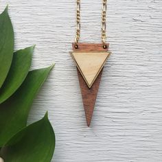 "Rose and Peddle makes light weight wooden jewelry that is a unique, modern addition to any outfit. The natural wood color goes with almost anything, fancy or casual! ------------ Design: This pendant is made of two laser cut wooden pieces. The base is made of vibrant cherry wood and the inner triangle is maple, separated with a delicate brass accent. ------------ About: The overall pendant is approximately 1\" x 2\" and made from 1/4\" wood 30\" Gold Plated Chain No Clasp ------------ Whether i Chain Jewellery, 5th Anniversary, Wood Necklace, Geometric Jewelry, How To Make Light, Laser Cut Wood, Gift For Girlfriend, Anniversary Gift For Her, Wooden Jewelry