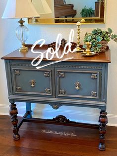 an old dresser is painted blue and gold with the word sold over it's top