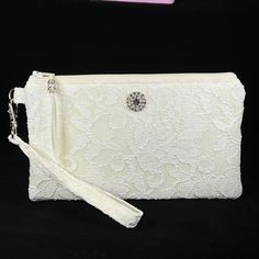 Bridal Ivory Wristlet Purse for the bride to be.  Designed to hold your essentials, this wristlet is small enough to carry easily, but big enough for all your needs!   This purse is made in Ivory Lace, and is suitable for a wedding, as a clutch for the bride, bridesmaid, or use with an evening formal.   Can also be used as a Makeup Bag, Phone Holder, or a Gift For The Bride. *Please note the Wristlet you receive will vary from the one pictured due to the cut of the fabric. The features of this w Elegant Beige Clutch With Wrist Strap, Elegant Handheld Clutch With Wrist Strap, Elegant Evening Wristlet, Elegant Cream Bag With Wrist Strap, Cream Pouch Wristlet For Gift, Cream Pouch Wristlet Gift, Cream Pouch Wristlet As Gift, Elegant Formal Clutch With Wrist Strap, Elegant Beige Bags With Wrist Strap