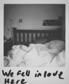 a black and white photo of an unmade bed with the words we all in love here written on it