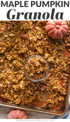 homemade maple pumpkin granola on a baking sheet with a spoon in it and text overlay that reads maple pumpkin granola