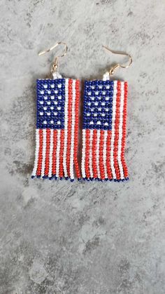 Celebrate your patriotism with these Awesome Flag Earrings, meticulously crafted from red, white, and blue seed beads, and featuring a gold-plated hook. Standing 2 1/2" in height, these earrings are perfect for showcasing your American pride, especially on the 4th of July. Their vibrant colors and detailed design make them a standout accessory for any patriotic occasion. Whether as a festive addition to your own collection or as a thoughtful gift, these earrings embody the spirit of celebration and national pride in a stylish and fun way. Blue Patriotic Earrings For Independence Day, Patriotic Blue Earrings For Independence Day, Patriotic Earrings For 4th Of July, Patriotic Multicolor Dangle Jewelry, Patriotic 4th Of July Earrings, Patriotic Dangle Earrings For Independence Day, Patriotic Blue Beaded Earrings, Patriotic Multicolor Earrings For Independence Day, Adjustable Red Patriotic Earrings