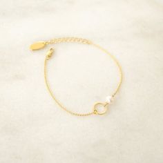 This delicate and minimalist Karma and Pearl Bracelet is an everyday Bracelet, great on its own or stacked for a fashionable look. This Bracelet is composed of a tiny round charm mounted on a chain with a lobster clasp closure, and a natural fresh water pearl. 16K Gold plated components.Pendant diameter : 1cm  Pearl Diameter : 0.5cmThe bracelet measures 15cm (6.2") , plus a 3cm extender chain.All metallic component are 16K Gold Plated and lead and nickel free.All Nibbana jewels come in a lovely Minimalist Pearl Bangle Bracelet Gift, Dainty Metal Pearl Bracelet Perfect As A Gift, Dainty Metal Pearl Bracelet As Gift, Dainty Pearl Bracelet As Gift, Dainty Metal Pearl Bracelet Gift, Minimalist Everyday Pearl Bracelet With Adjustable Chain, Delicate Metal Bracelets For Everyday Wear, Everyday Minimalist Pearl Bracelet With Adjustable Chain, Minimalist Metal Charm Bracelet